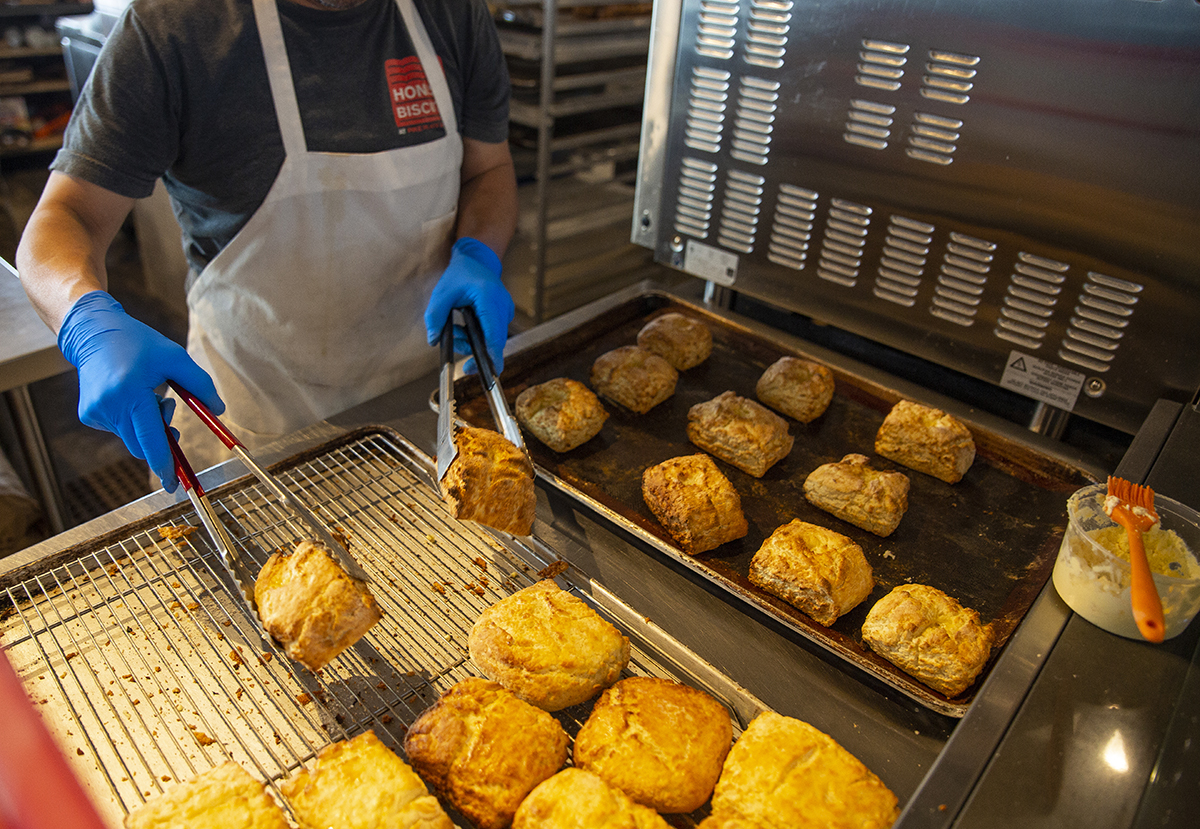 Food processor wearing nitrile gloves makes bread.