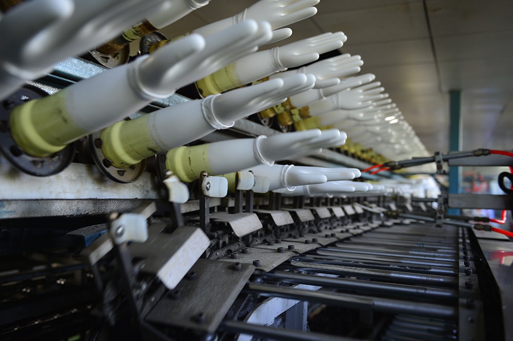 Disposable glove formers sit at the ready in a SE Asia factory.